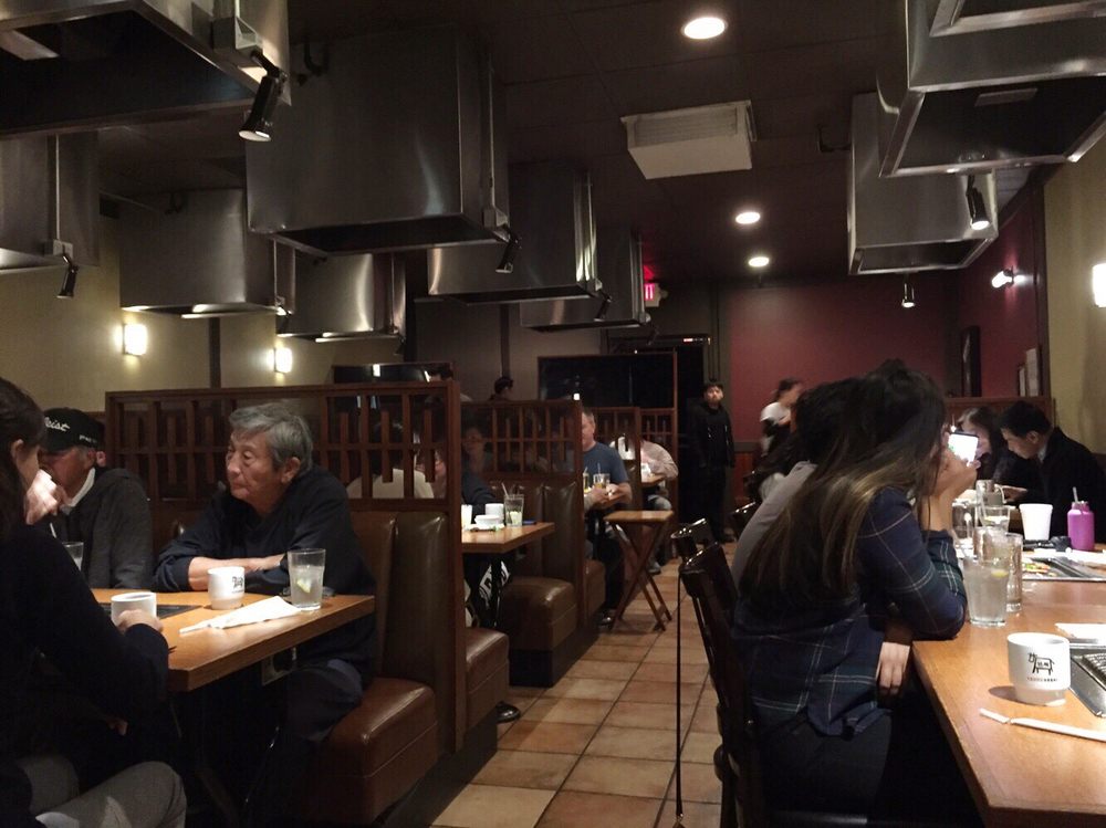 Dining room with booths and a grill vent over every table